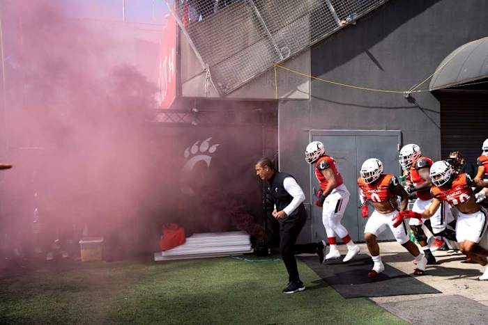 Cincinnati Bearcats head coach Luke Fickell takes the field before the NCAA Football game between the Cincinnati Bearcats and the South Florida Bulls at Nippert Stadium in Cincinnati on Saturday, Oct. 8, 2022. South Florida Bulls At Cincinnati Bearcats 156